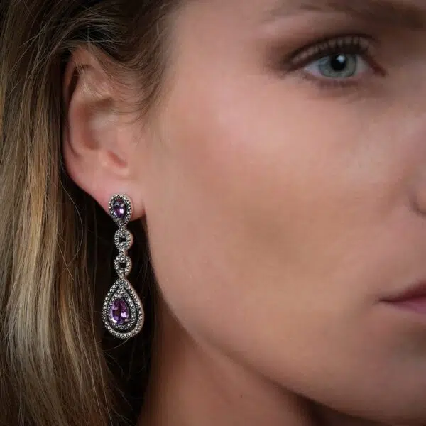 Marcasite and amethyst silver valkyrie Paris earrings worn by a model on the right ear.